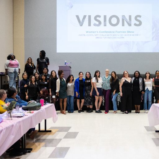 Attendees and presenters gather for a group photo under a sign that proclaims VISIONS at the ACC Women’s Health, Motivation, and Empowerment Conference