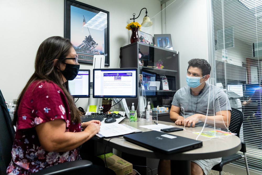 RS16942_20210824-RVS-Financial-Aid-Advising-ca-055-scr ACC Veterans Affairs & Financial Aid Specialist Sandra Diaz assist ACC student Christopher Gutierrez at the Riverside Campus on Tuesday, August 24, 2021, during the first week of the fall 2021 semester.